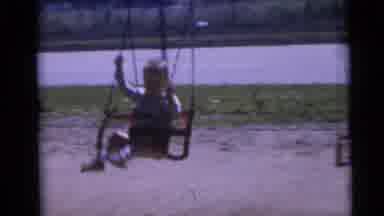 Camden New Jersey USA (1960): Two Young Children Play On Swings With A Fence And