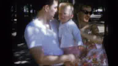 Camden New Jersey USA (1960): Mother And Father Holding Child Outside
