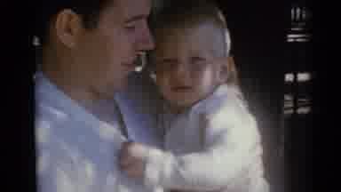 Camden New Jersey USA (1960): Dad Wearing White Shirt Holds Little Boy Tightly As