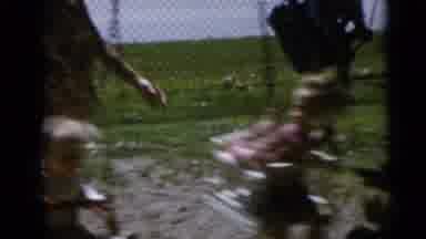 Camden New Jersey USA (1960): Mothers Rocking Kids On A Swing Park With Grass Near
