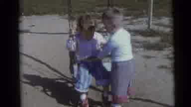 Camden New Jersey USA (1960): Girl Stuck On Swing Is Helped By Boy Who Attempts To