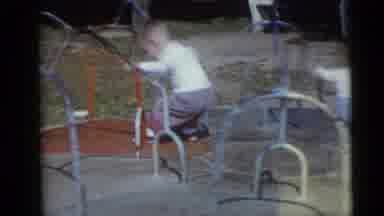 CAMDEN NEW JERSEY USA-1960: Two Babies Play On The Spinning Ride At The