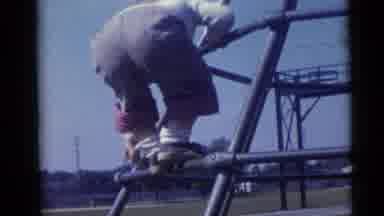 Camden New Jersey USA (1960): Kid Climbs Up Jungle Gym While Sibling Follows