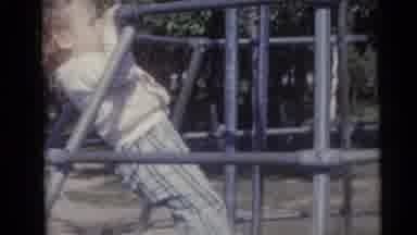 Camden New Jersey USA (1960): Little Girl Struggles To Climb The Jungle Gym