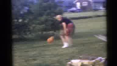 Camden New Jersey USA (1960): Person Wearing Red Shorts Tosses Orange Ball In Air