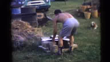 Camden New Jersey USA (1960): Woman Wearing White Shirt Watches Man Stack Items On