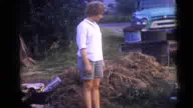 Camden New Jersey USA (1960): Woman In A Yard Near A Pile Of Branches Man Walking