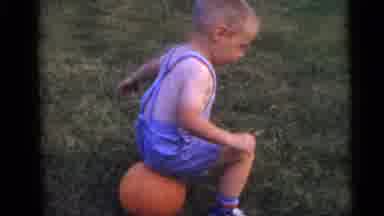 Camden New Jersey USA (1960): Boy Trying To Pot A Balloon By Sitting On It