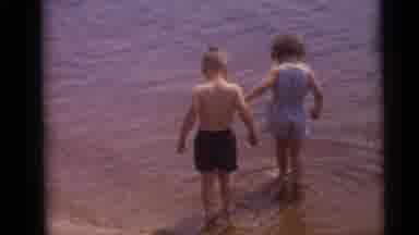 Camden New Jersey USA (1960): Small Boy And Girl Slowly Walk Into Shallow Water