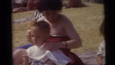 Camden New Jersey USA (1960): Woman On Sand On A Blanket Feeding Her Children Some