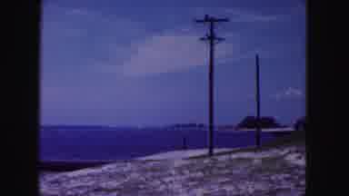 Miami Florida USA (1960): Power Line Poles Run Along A Beach With White Sand And