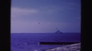 Miami Florida USA (1960): Driving Across A Bridge Over Water Toward A Lighthouse