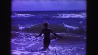 Miami Florida USA (1960): Woman Walking Into The Ocean As A Wave Crashes Into Her
