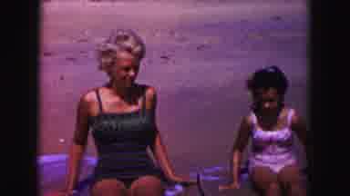 Miami Florida USA (1960): A Mother And Her Two Young Daughters Sitting On A Beach