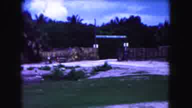 Miami Florida USA (1960): Outside Of A Tribal Looking Village A Man Nods And Waves