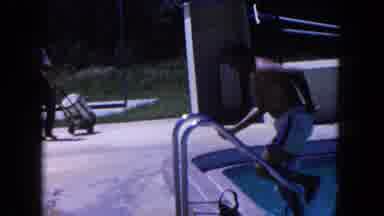Miami Florida USA (1960): A Man Exits A Pool And A Young Girl Covers Her Nose In