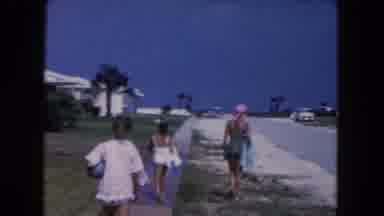 Miami Florida USA (1960): Girl Wearing White Swimwear Walks Towards Beach On A