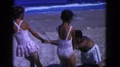 Miami Florida USA (1960): Two Daughters Pull Dads Arms Whos Legs Are Buried In The