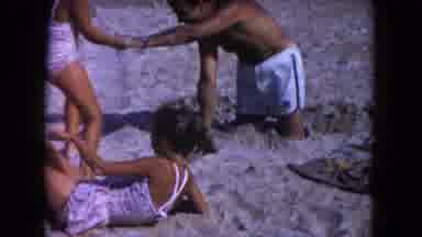 Miami Florida USA (1960): A Little Girls Are Their Dad Covered His Feet In The