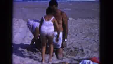 Miami Florida USA (1960): Man And Girls Wearing White Swimwear Play In Sand On A