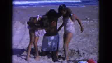 Miami Florida USA (1960): Father And Daughters Play On The Beach Together And