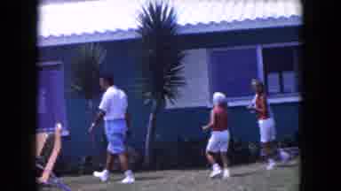 Miami Florida USA (1960): Man And Two Women Walking By Blue House With White Roof