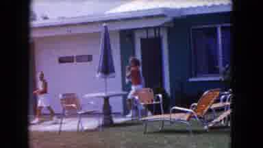 Miami Florida USA (1960): A Blue Car On The Road Then A Shot To Two Kids Outside