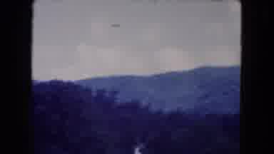 Miami Florida USA (1960): A Car Drives Past Mountains A House And A Man Dressed As