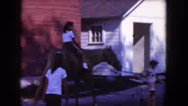 MIAMI FLORIDA USA-1960: A Girl Rides A Horse As Another Girl Leads It By The Reins