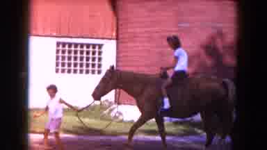 Miami Florida USA (1960): Child Leading Another Child On A Horse In Front Of A