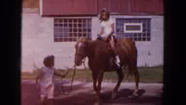 Miami Florida USA (1960): Child Riding Horseback While Sibling Leads