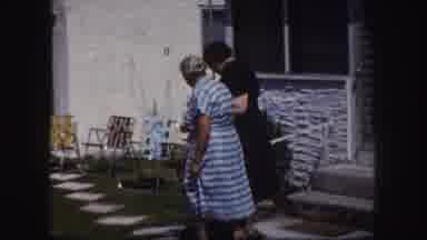 Tampa Florida USA (1960): A Younger Woman Assisting An Older Woman In To Her Home