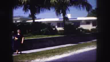 Tampa Florida USA (1960): Two Women Walking Arm In Arm On A Sidewalk With Houses