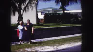 Tampa Florida USA (1960): Two Older Women Walking Down A Sidewalk Together Arm In