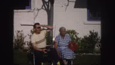 Tampa Florida USA (1960): Couple Sits In Lawn Chairs On A Bright Sunny Day
