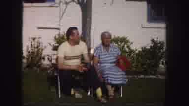 Tampa Florida USA (1960): A Man And An Older Woman Are Sitting Together While Cars
