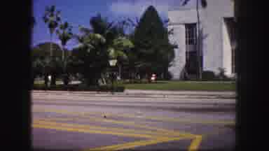 Tampa Florida USA (1960): People Walking Away From White Building On A Clear Day