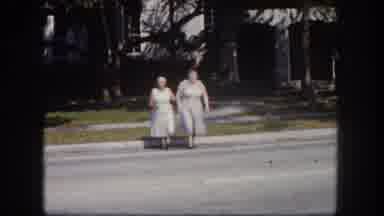 Tampa Florida USA (1960): Two Elderly Women Crossing A Road Together Weather Long