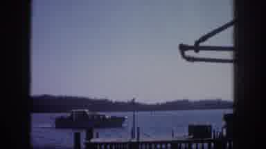 Tampa Florida USA (1960): People Sit On The Dock And Watch Boats Gently Sail By On