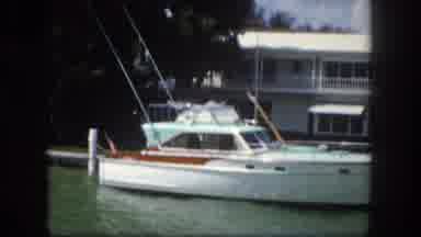 Tampa Florida USA (1960): Moving Down A River Past A Boat And A House