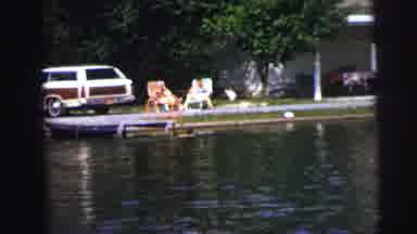 Lynbrook New York (1976): Two People Sitting In Lawn Chairs Next To And Observing