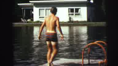 Lynbrook New York (1976): Young Man In Swimming Trunks Carefully Walking On A Dock