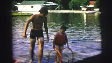 Lynbrook New York (1976): Person Wearing Striped Shorts Climbs Down From Pier Into