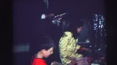Lynbrook New York (1976): Children Unwrap Gifts Together While Sitting On The