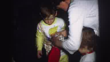 Lynbrook New York (1976): Mother Hands Out Christmas Stockings To Children And One