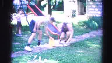 Hagerstown Maryland Usaa (1963): Two Young Kids Light Small Fireworks Under Sand