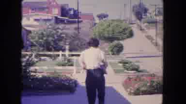 Tijuana Mexico (1962): Middle Aged Woman Walking Backward Down Sidewalk As A Car