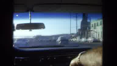 Tijuana Mexico (1962): A Person Nods Before Cutting To Footage Of Driving In