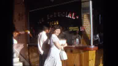 Tijuana Mexico (1962): A Woman Waits At An Outdoor Store Counter And Waves At The