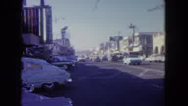Tijuana Mexico (1962): A Man Walks Across A Street At A Crosswalk While Traffic